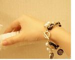 Buy Crunchy Fashion Black Flower Pearl Multilayer Bracelet - Purplle